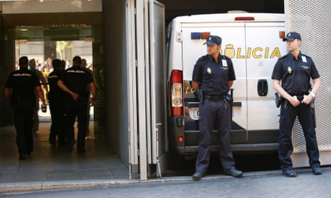 Spanish police guard a van in which Ashya King's parents arrived  at court.