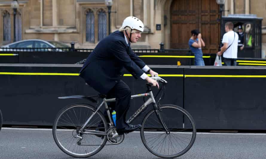 Boris Johnson, the mayor of London, rides his bicycle past the Houses of Parliament in 2013