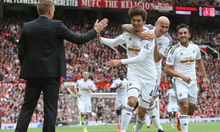 Ki Sung-Yeung of Swansea City celebrates scoring their first goal with manager Garry Monk.