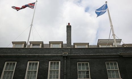 A Union flag and a Scottish Saltire flag fly over Downing Street on September 10, 2014 in London