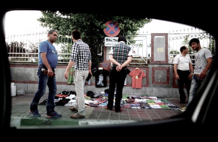 Iranians shop for shirts from a street vendor at Azadi Square in western Tehran on June 4, 2013.