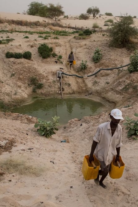 Men collect water from one of Timbuktu's few remaining waterholes.