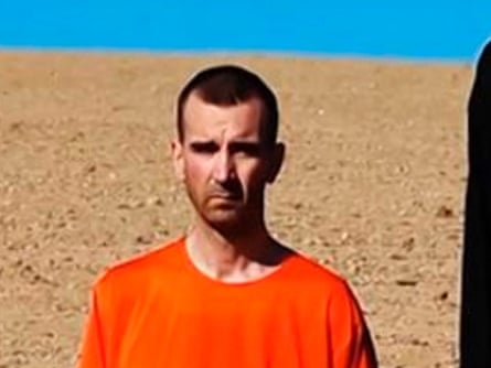 A still from a video purportedly showing British hostage David Haines kneeling next to an Islamic State fighter.
