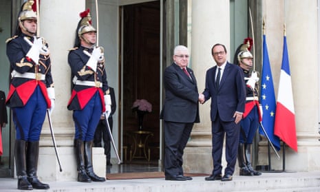 Iraqi President Fouad Massoum and French President Francois Hollande shake hands ahead of Paris conference.