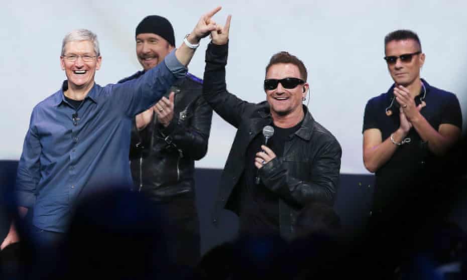 U2 and Apple CEO Tim Cook celebrated the band's album giveaway, but some iTunes users weren't so happy.