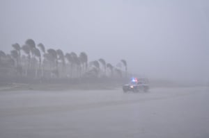 A vehicle is seen in heavy rain in Los Cabos. Mexican authorities evacuated inhabitants from vulnerable coastal areas