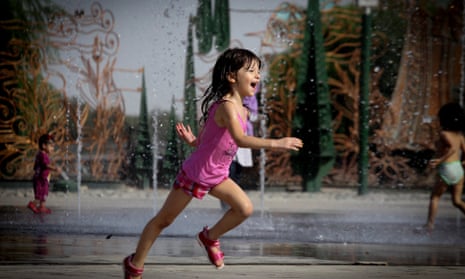 An Iranian girl runs at a park in Tehran, Iran, during a heatwave. August 2014 was the hottest on record, globally