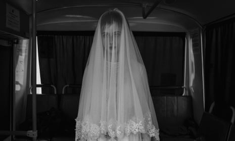 Rada, 14, tries on a wedding dress designed by her sister in Chechnya