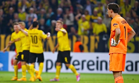 Arsenal's Szczesny watches as Dortmund players celebrate in Champions League match in Dortmund