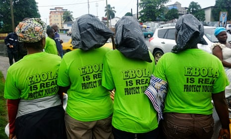 City workers prepare to clean the streets in the centre of the Liberian capital, Monrovia. green