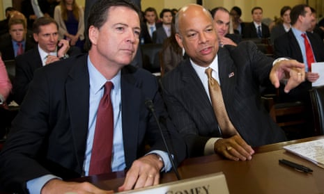 FBI Director James Comey, and Department of Homeland Security Secretary Jeh Johnson, right, talk before the start of a House Homeland security committee.
