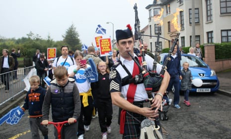 A man plays the bagpipes on a "short walk to freedom" march in Edinburgh.
