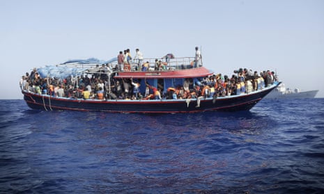 Migrants are taken to the mainland after being rescued by the Italian navy