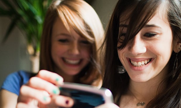 Two teenage girls using a smartphone.