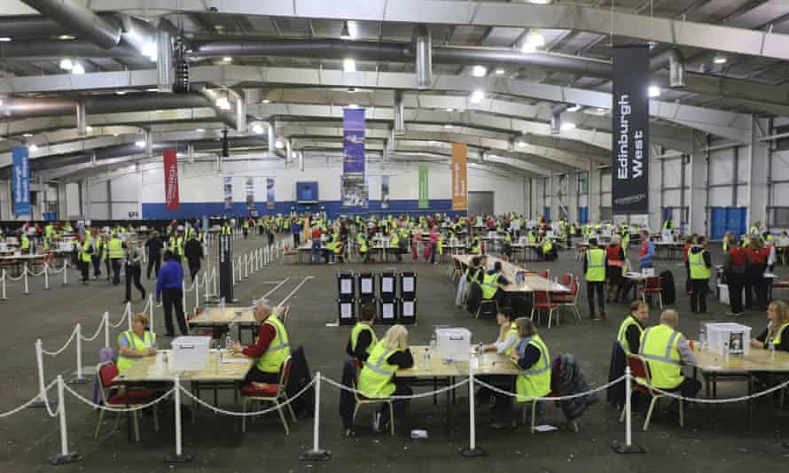 Members of staff wait inside a counting centre to begin tallying votes in Edinburgh.