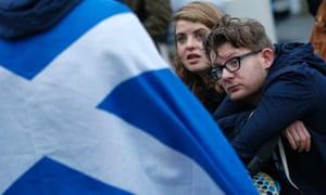 A couple sit outside the Scottish Parliament in Edinburgh this morning
