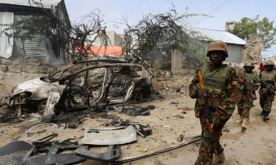 Ugandan soldiers from the African Union Mission in Somalia (Amisom) patrol after the Mogadishu prison attack blamed on al-Shabaab militants.