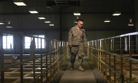 A US military guard watches over detainee cells inside the Parwan detention facility near Bagram Air Field.