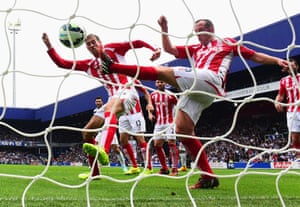 Peter Crouch and Charlie Adam of Stoke City fail to stop the header by Steven Caulker of QPR for the equalising goal.