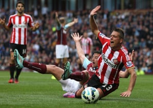 Lukas Jutkiewicz of Burnley tangles in the penalty box with Emanuele Giaccherini of Sunderland.
