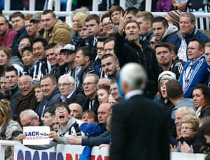 Newcastle United fans gesture towards team manager Alan Pardew.