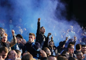 Chelsea's fans celebrate Andre Schürrle's goal against Manchester City at the Etihad stadium by letting off blue flares.