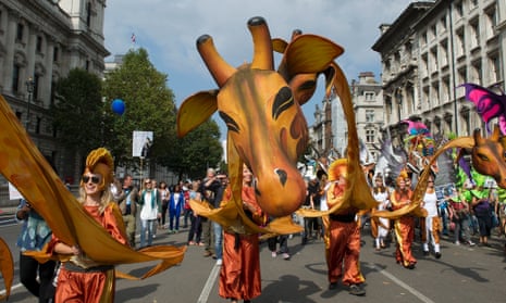 People with giraffe puppets march during The People's Climate March, central London, a march and rally to demand urgent action on climate change.