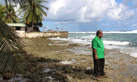 Marshall Islands president Christopher Loeak in front of his home. Loeak raised the height of a seawall around his home and concedes it is barely enough to protect his family from a ‘climate emergency’.