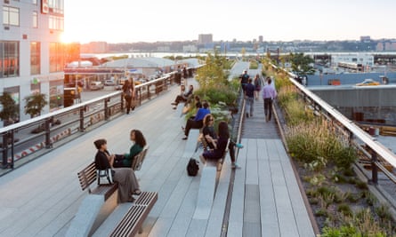 Visitors to the High Line sit on "conversation benches" as the sun sets over New York.