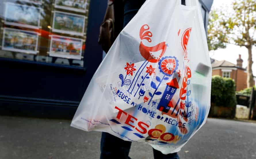 A shopper carries a Tesco supermarket bag in London, Monday, Sept. 22, 2014.