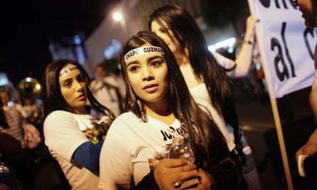 Young women wear headbands with Joaquín Guzmán's name, during a march to call for his freedom in his home state in the north-west of Mexico.
