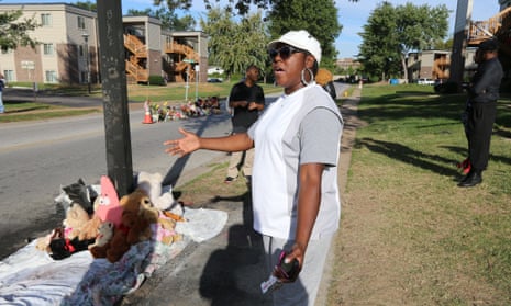 A woman gestures by a new teddy bear memorial near the spot of where Michael Brown was shot by Ferguson police office Darren Wilson.