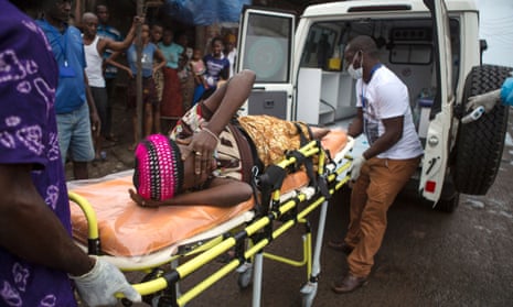 A pregnant woman suspected of contracting Ebola is lifted by stretcher into an ambulance in Freetown, Sierra Leone.