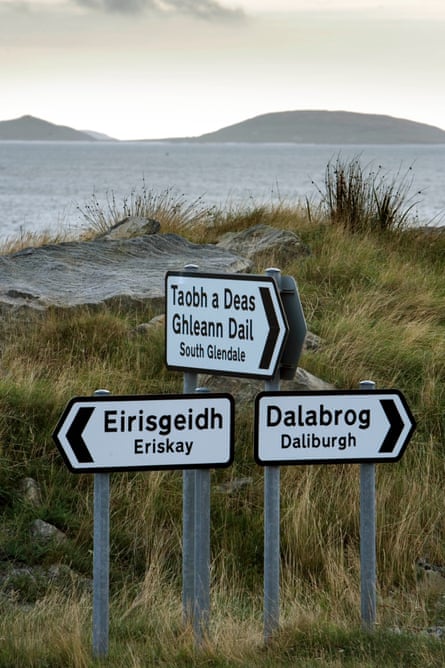 Gaelic language signs point the way at Ludag, South Uist, looking over the Sound of Eriskay