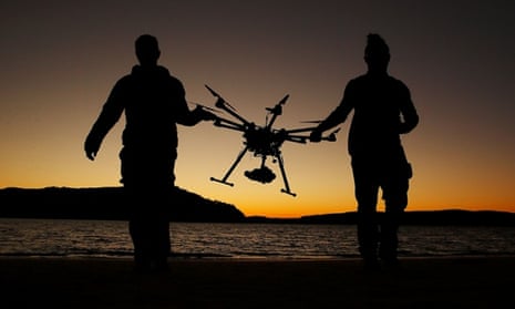 Drone operator, Ken Butti and Camera operator, Robbie Josephsen carry the custom built DJI s1000 Drone following a flight at Palm Beach on July 4, 2014 in Sydney, Australia. 