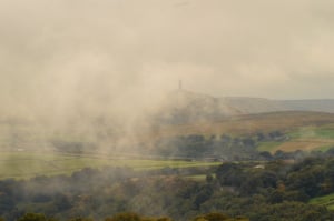 out of the mist Stoodley Pike in West Yorks appearing out of the September mist.