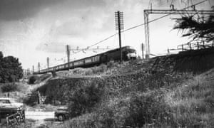 16th August 1963:  Scene of the great train robbery with the train waiting on an embankment above a country road.