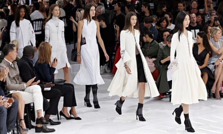 Employees of the Christian Dior fashion house salute the audience at the  end of the presentation of Dior's Fall-Winter 2012 ready-to-wear collection  during Paris Fashion Week March 4, 2011. Dior sacked British