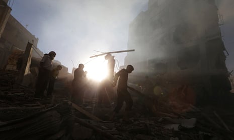 Residents in Douma, near Damascus, survey the aftermath of an airstrike