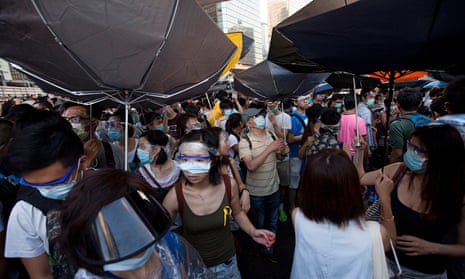 Pro-democracy protesters hold umbrellas against the threat of teargas and pepper spray in Hong Kong