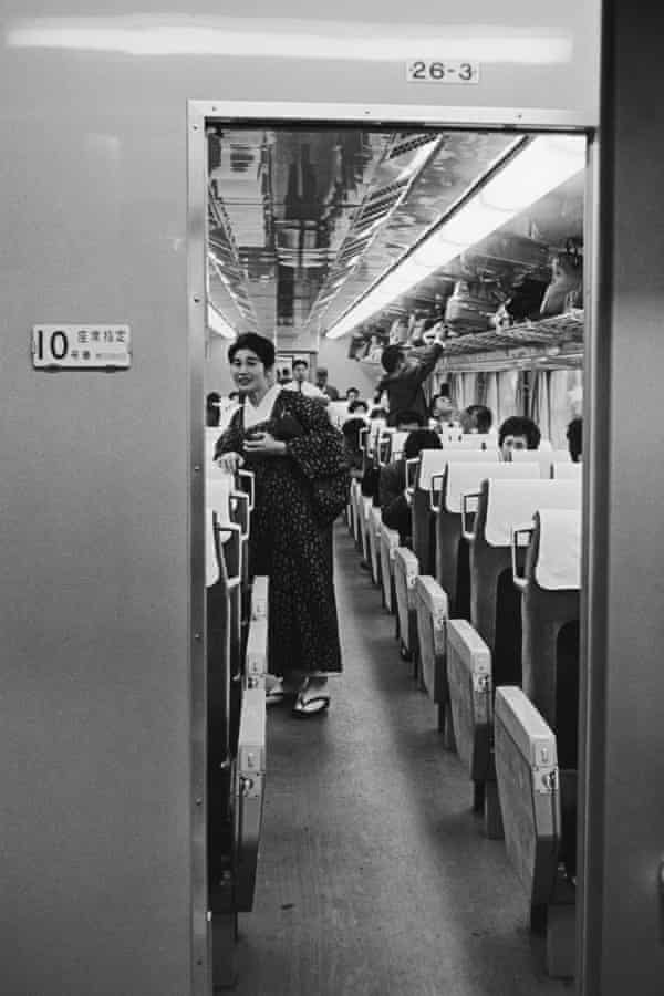 A passenger in traditional dress on board a Japanese hikari shinkansen bullet train in 1965.