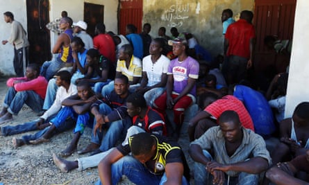 Illegal migrants rest after they were rescued by the Libyan coastguard when their boat sank off the coastal town of Garabulli, 60 km east of Tripoli on 15 September 2014.