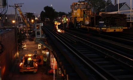 CTA workers work on the Milwaukee elevated track as part Your New Blue project improvements.