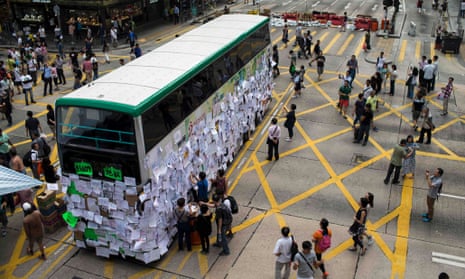A bus, with messages of support, stops at a main street at Mongkok shopping district after thousand of protesters blocked the road in Hong Kong.