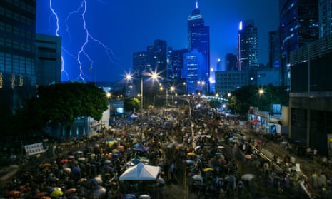 A lightning strike is seen over skyscrapers as demonstrators gather outside the central government complex as they protest during a heavy rain storm in Hong Kong