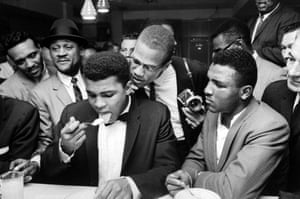 This is a scene from a party after Clay beat Sonny Liston for the heavyweight title. Such is the power of his celebrity, the assembled crowd are jostling around him simply to watch him eat. The proximity of Malcolm X to Clay serves as a neat metaphor for the closeness of their relationship at that time. 