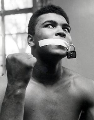A quick and homespun bit of showmanship which made for a striking photograph. Ali had been accused of being a loud-mouth for always predicting when he would beat his opponents. He needed no words and just two props to fashion a comic response to such criticism.