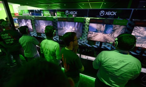 Gamers play the new 'Evolve' game at the Xbox exhibition.