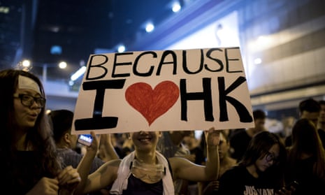 A woman holds a placard at a large pro-democracy protest in Hong Kong on October 1, 2014.