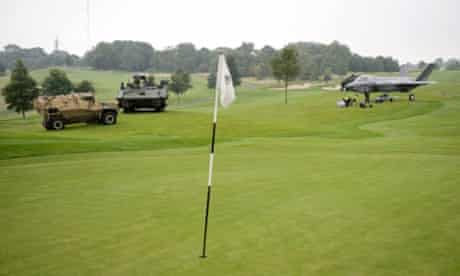 Scout Specialist Vehicle (2nd L) and a Foxhound armoured vehicle (L) and a full-size model aircraft displayed on the golf course of Celtic Manor Hotel
